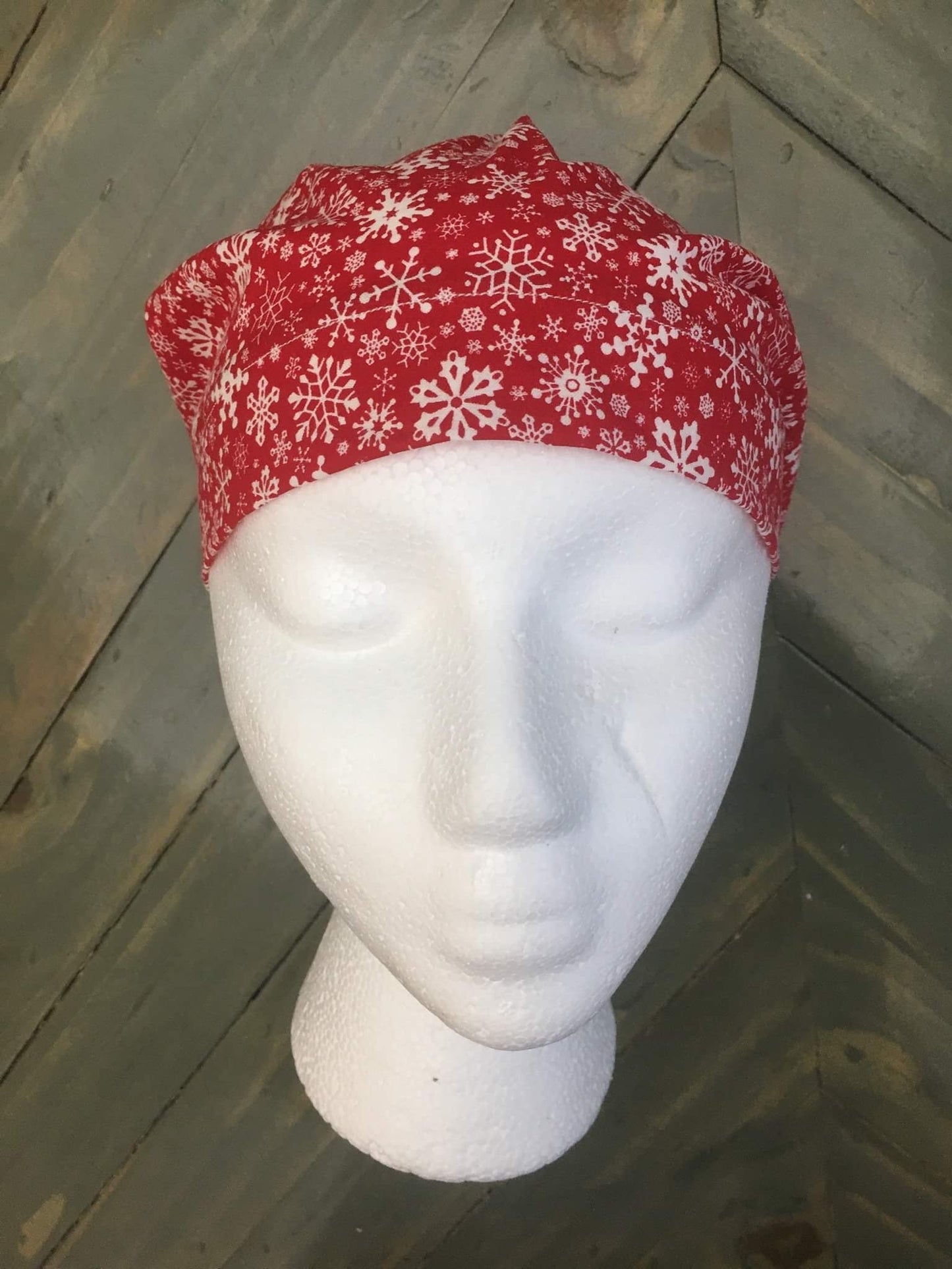 Snowflakes on red euro/bouffant style surgical hat.