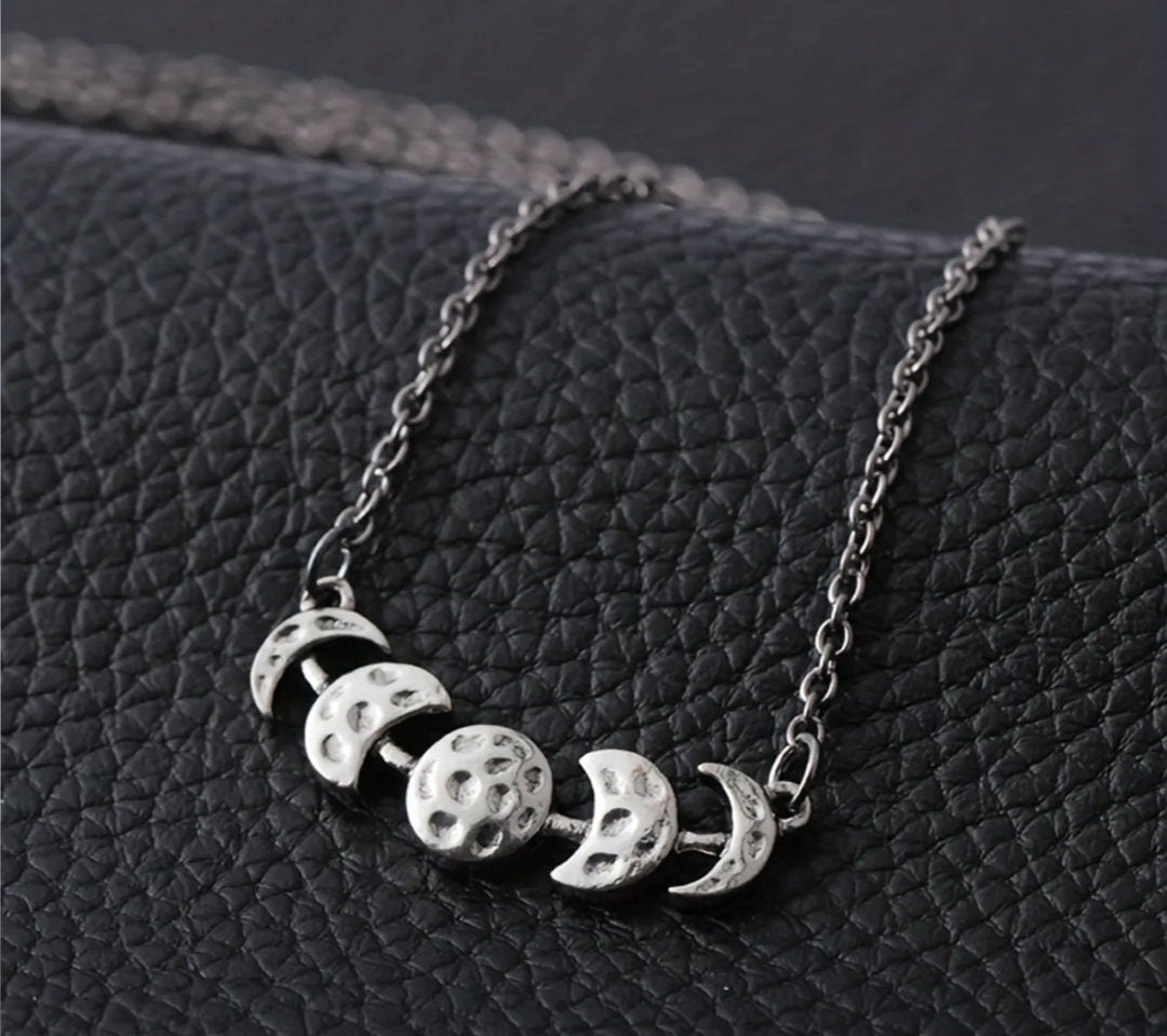 Phases of the moon hammered metal necklace on an 18 inch chain