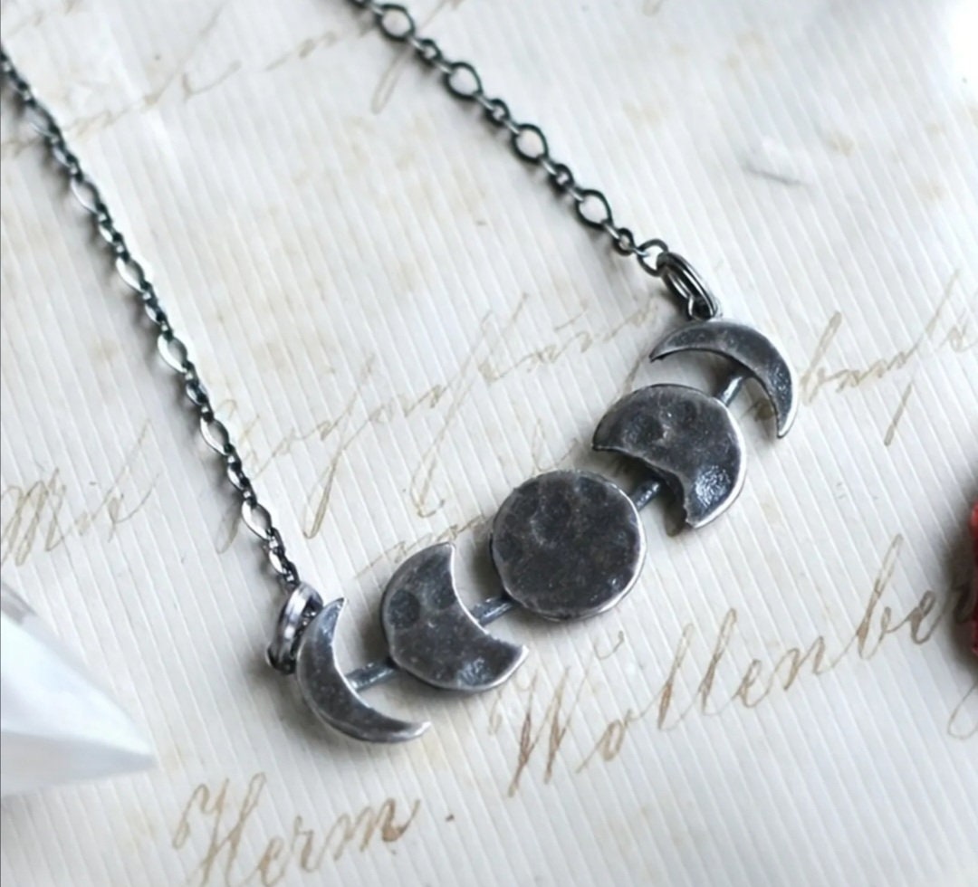 Phases of the moon hammered metal necklace on an 18 inch chain